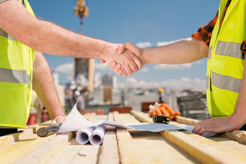 construction workers shaking hands